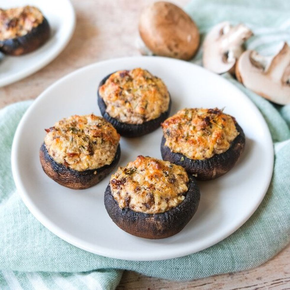 four stuffed mushrooms on a plate