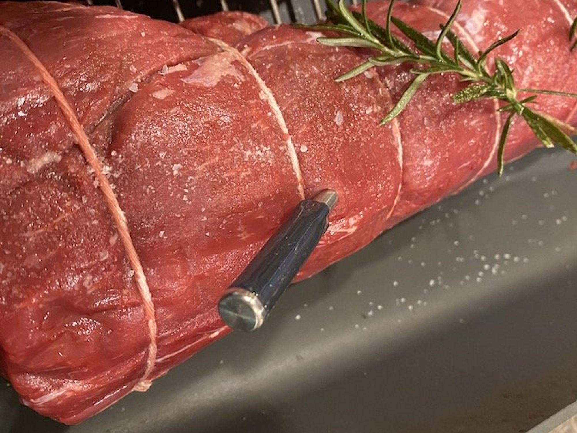 a photo of the MeatStick smart meat thermometer inserted in a roast beef