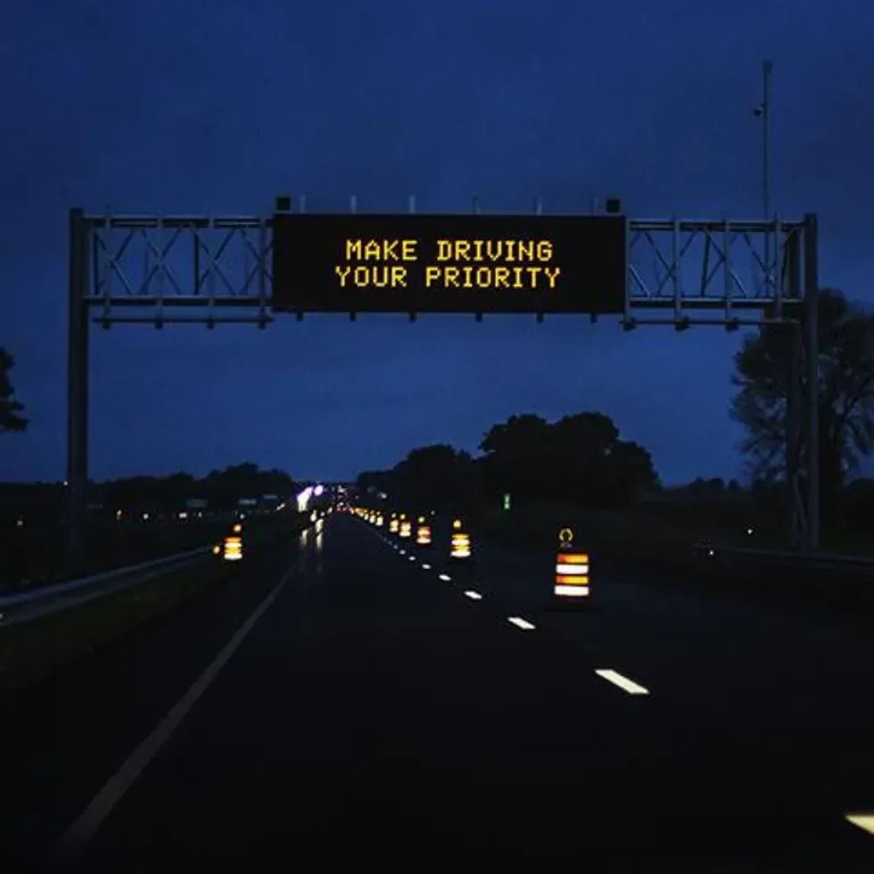 A Make Driving Your Priority highway sign