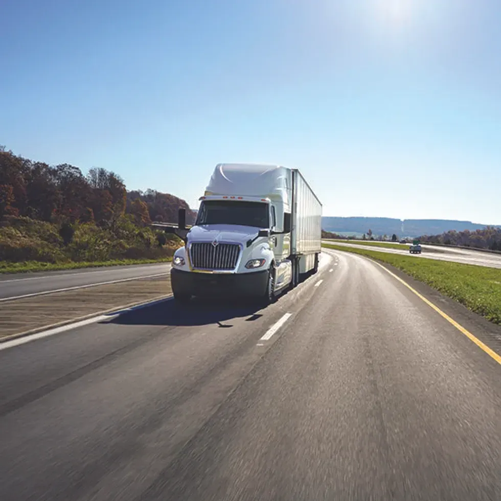 A white Penske semi on the road