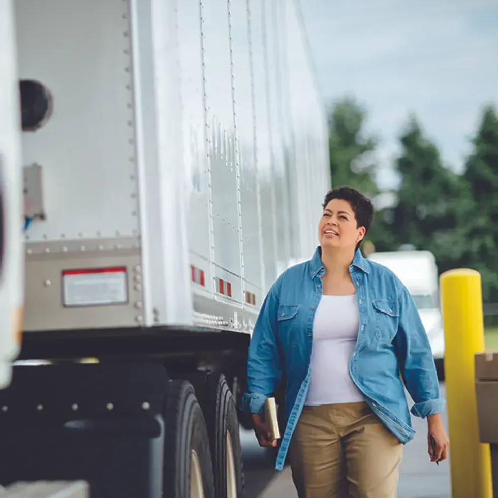 A truck driver conducts a vehicle inspection