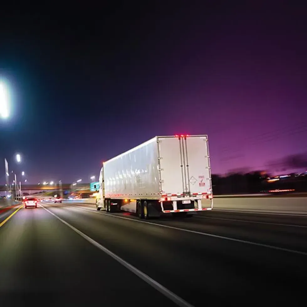 Semi-truck driving at night.
