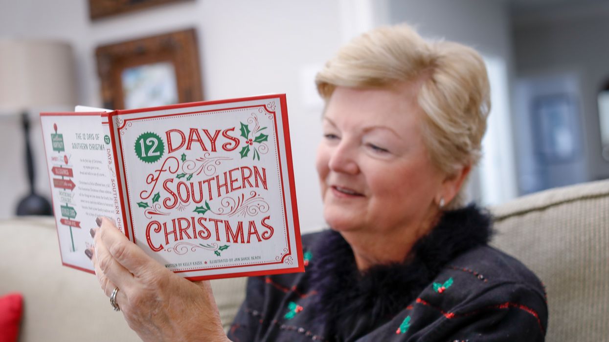 Diane Waud reads a copy of It's a Southern Thing's "12 Days of Southern Christmas" book.