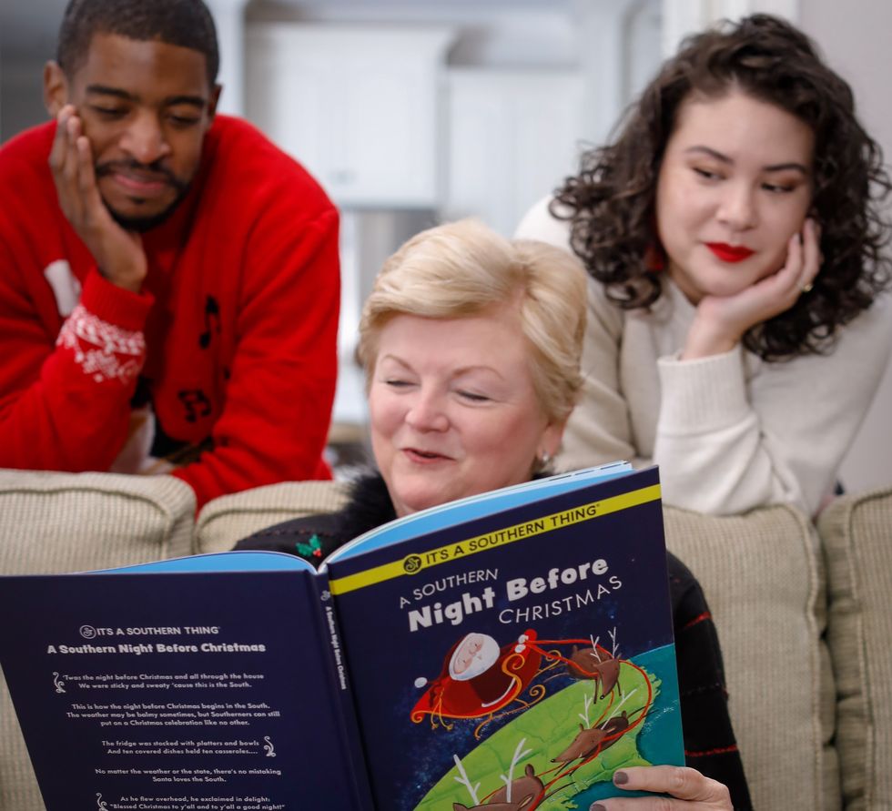 Three people read the "A Southern Night Before Christmas" book.