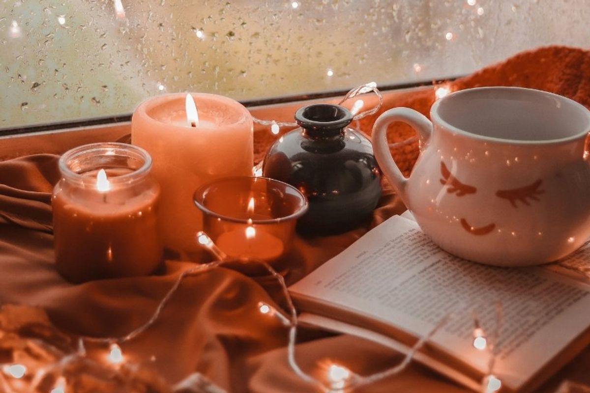 warm lights and candles on a window sill