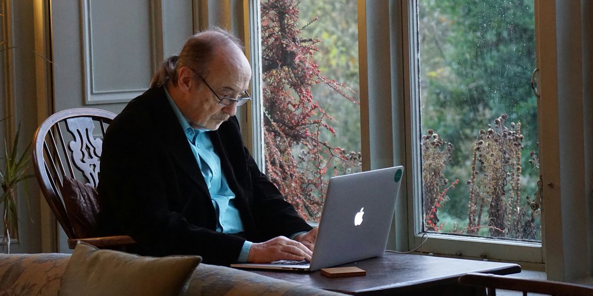 Elderly man working on a laptop