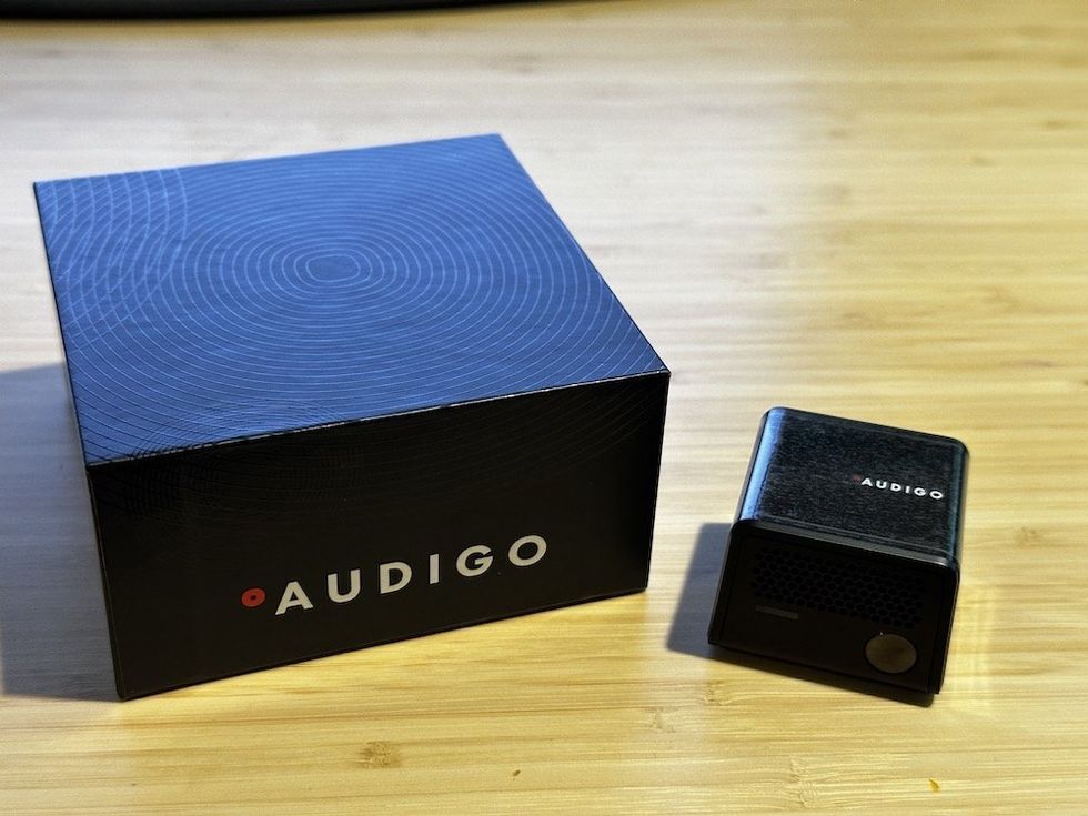 a photo of Audigo Wireless Smart Mic and box on a desktop