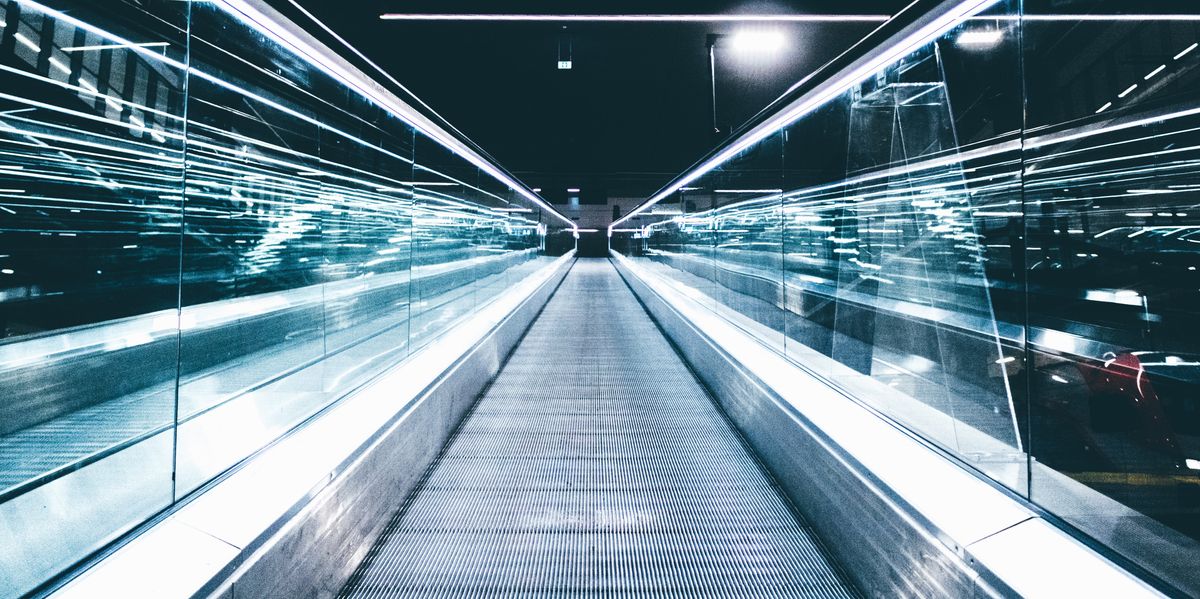 gray conveyor between glass frames at nighttime