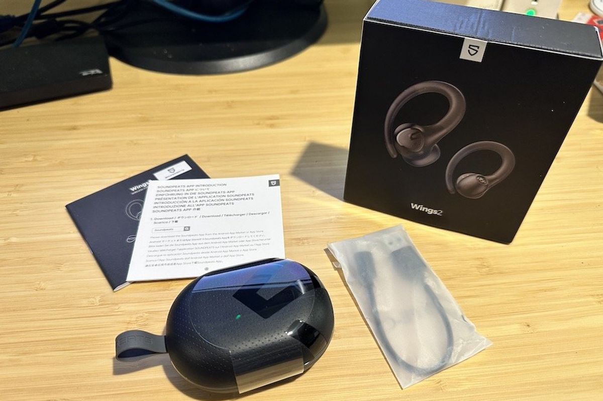 SoundPEATS Wings2 Sport Over-Ear Wireless Earbuds unboxed on a desk