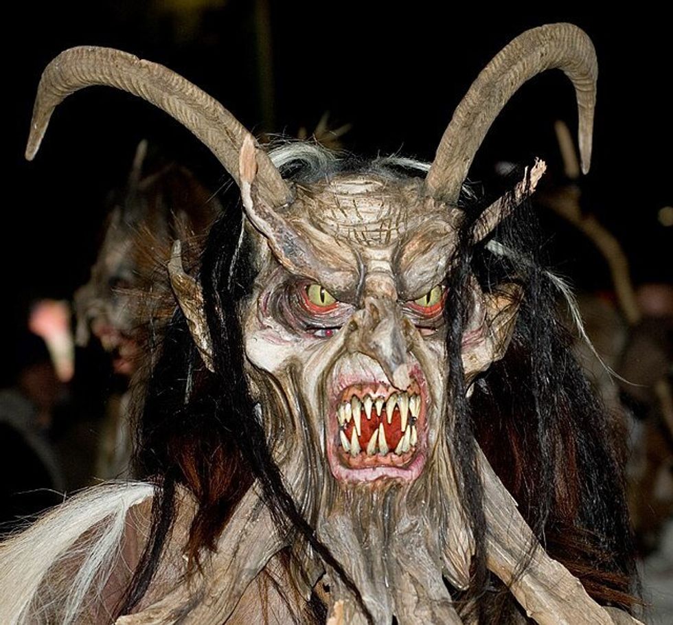 person wearing a scary looking horned mask