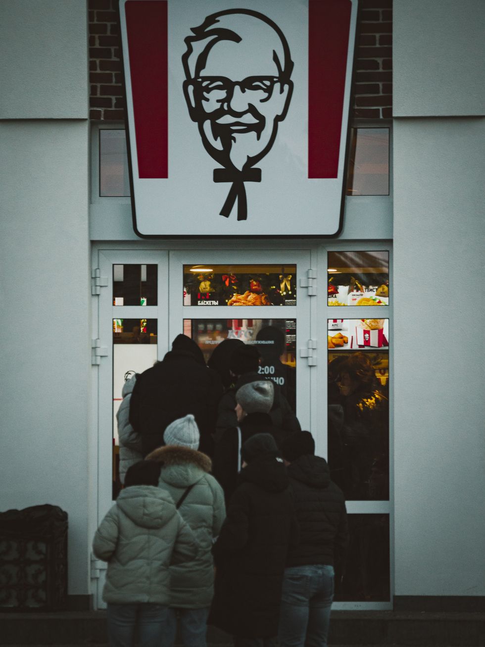 people lined up outside a Kentucky Fried Chicken