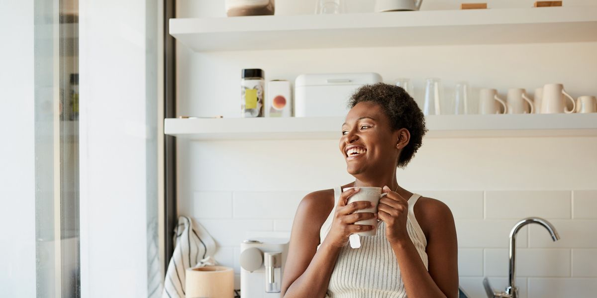young-black-woman-having-warm-herbal-tea-in-her-kitchen-during-the-day