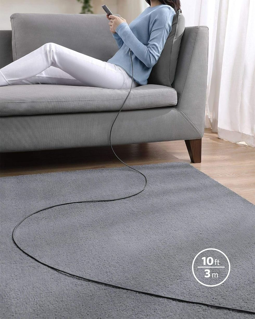 woman on couch with extra long charger attached to her phone