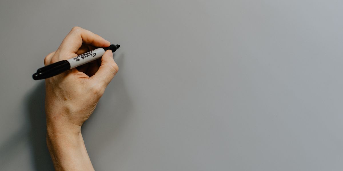 Left-handed person holding a Sharpie