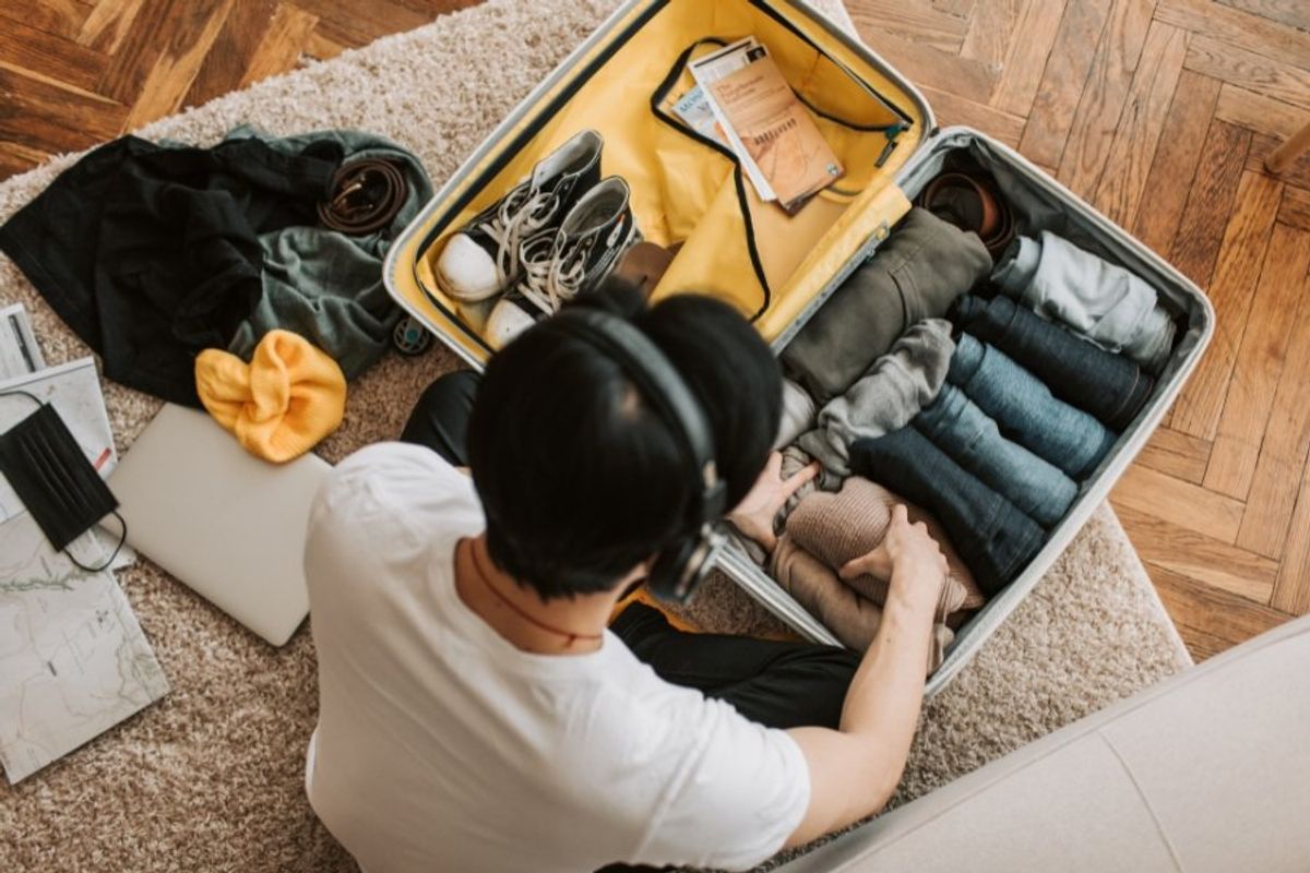 man packing a suitcase