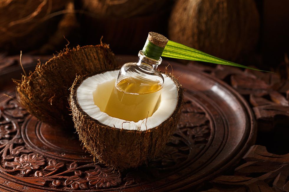 bottle-of-coconut-oil-inside-of-an-open-coconut