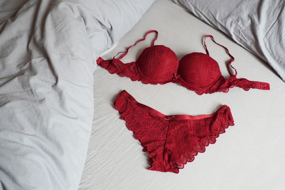 red-lace-lingerie-on-white-bed-sheets
