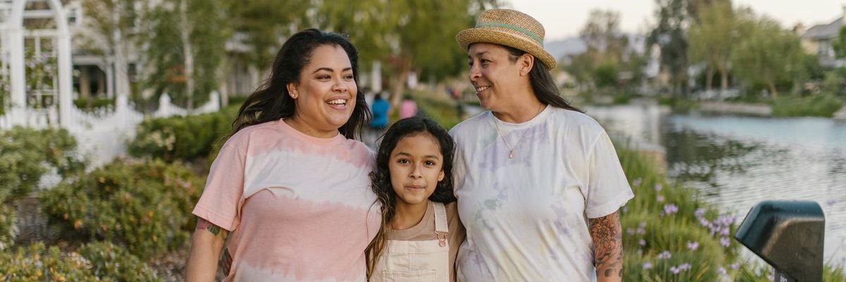 Latine family walking through a park