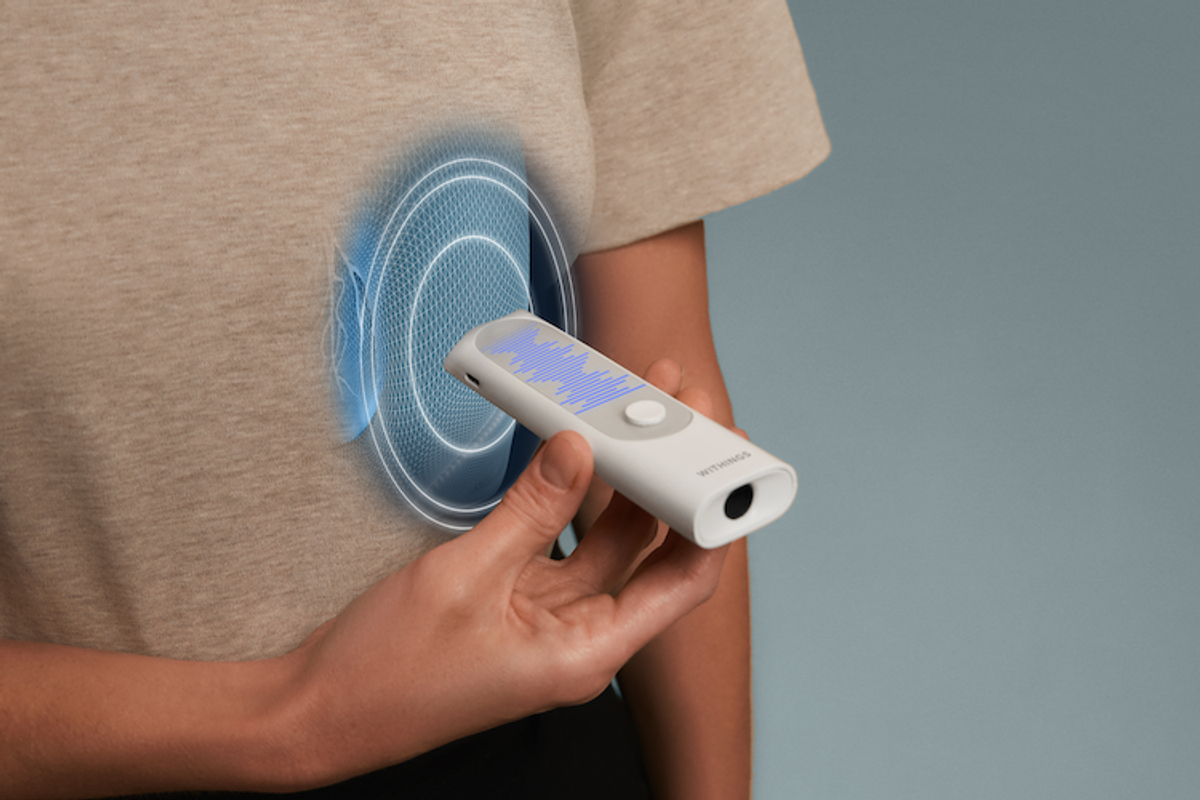 a photo of a woman using Withings BeamO on her body