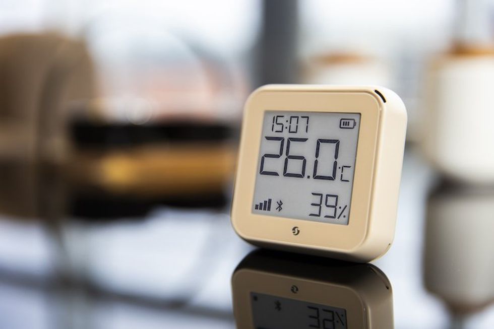 a photo of Shelly H&T Gen3, the next-gen Wi-Fi smart sensor on a table showing the temperature