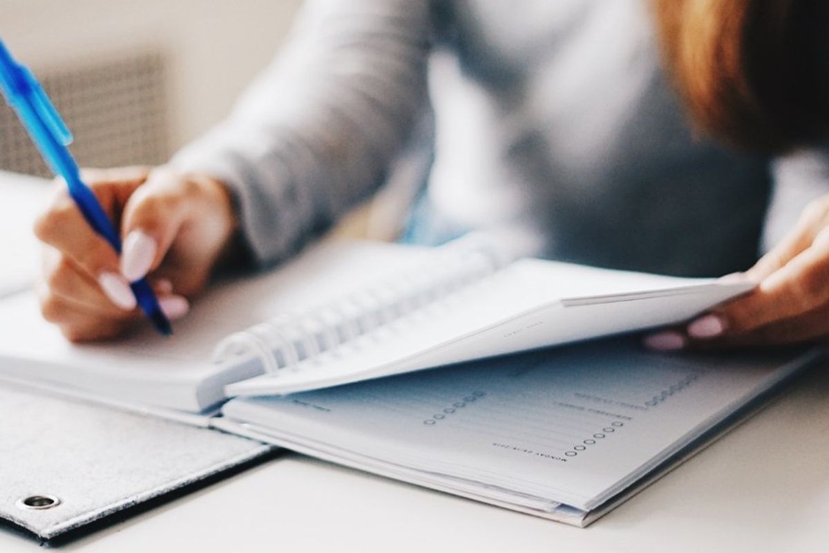 woman writing in a planner