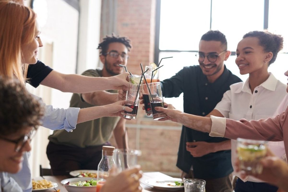 friends clinking glasses together in a toast