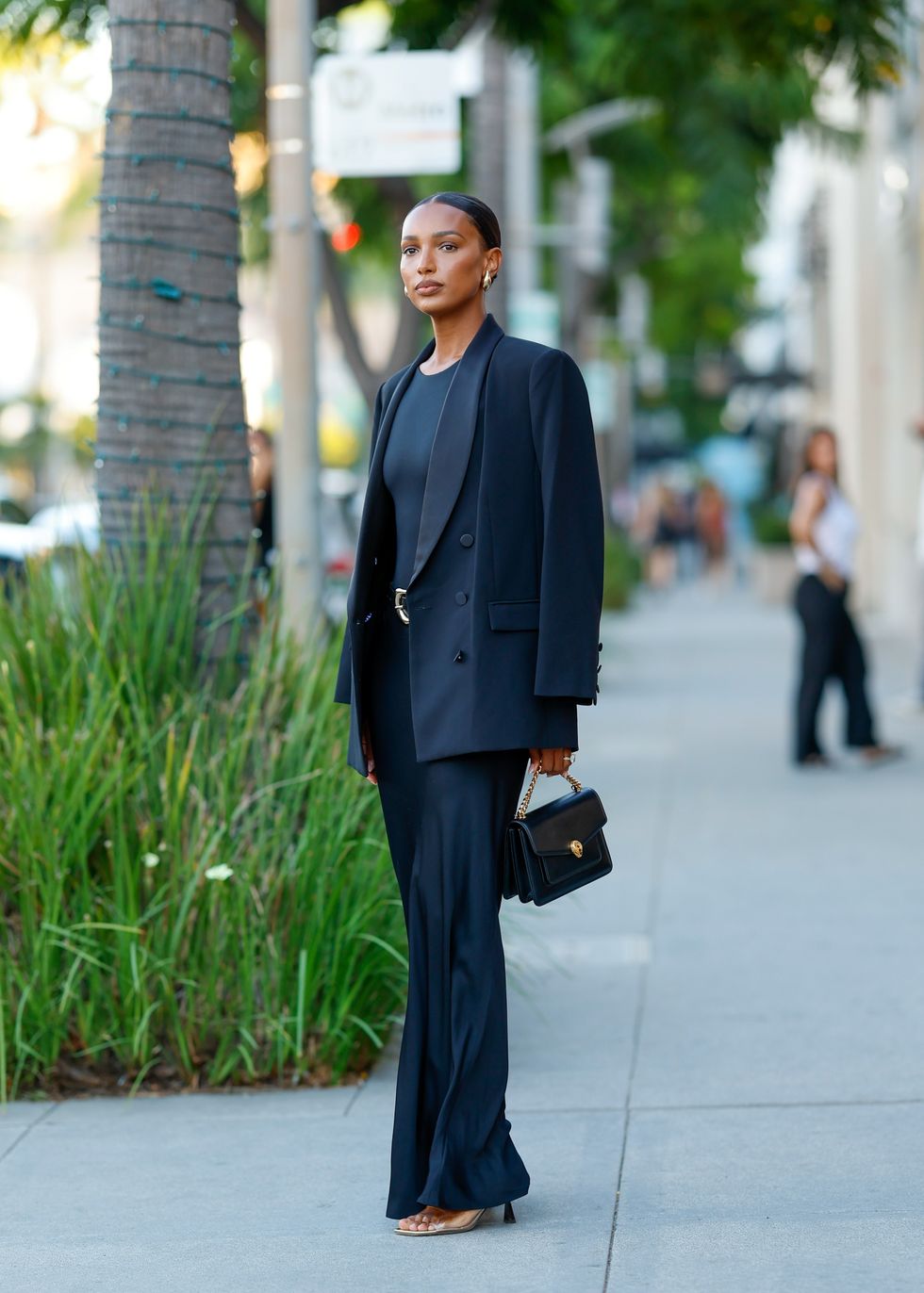 Jasmine-Tookes-stands-outside-wearing-a-structured-blazer