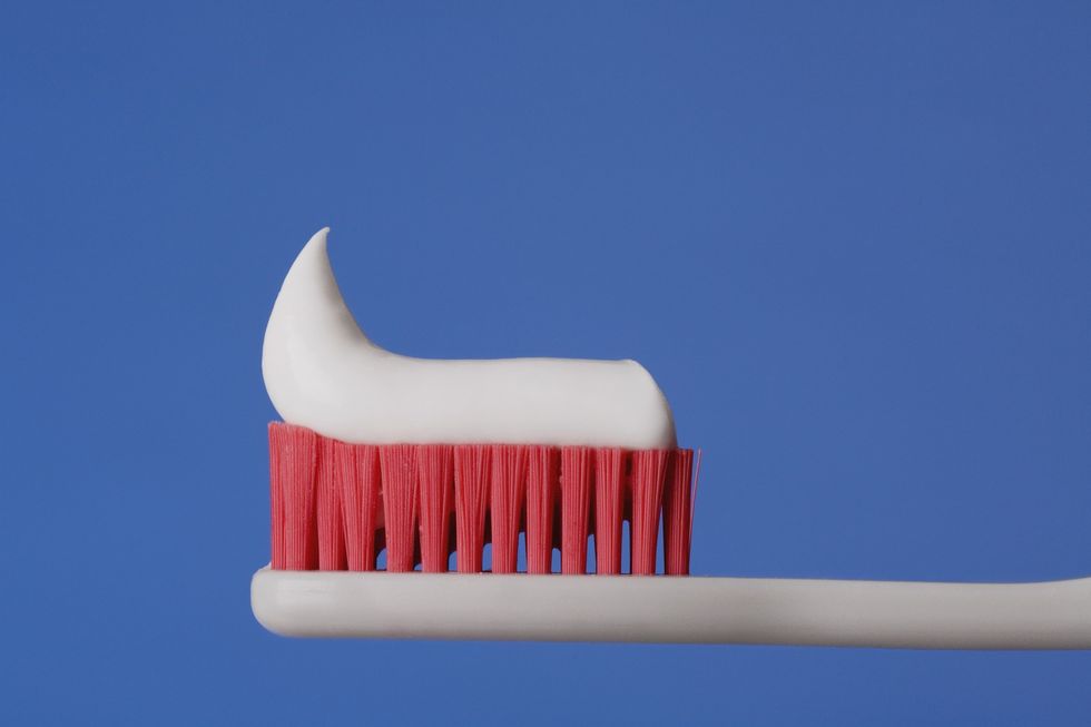 Close-up-of-toothbrush-with-white-toothpaste-on-the-bristles