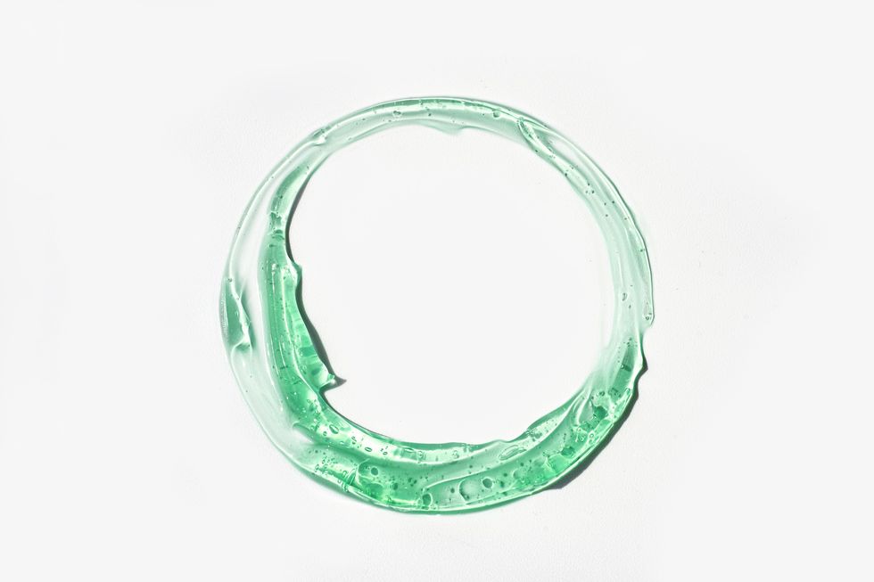 Light-green-gel-painted-in-a-circle-shape-on-plain-white-background