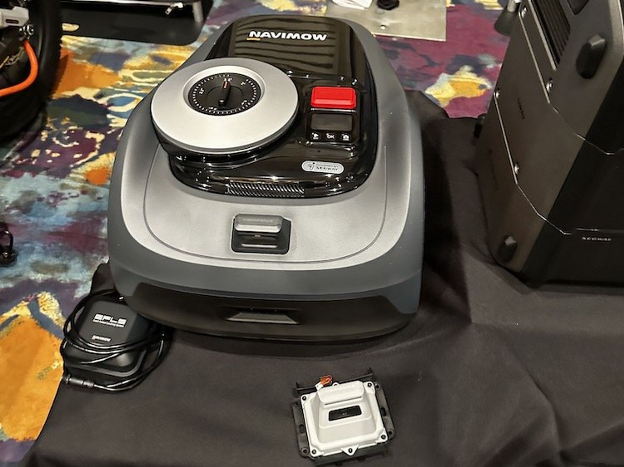 a photo of Segway Navimow i Series robot mower and AI Camera at CES Show 2024
