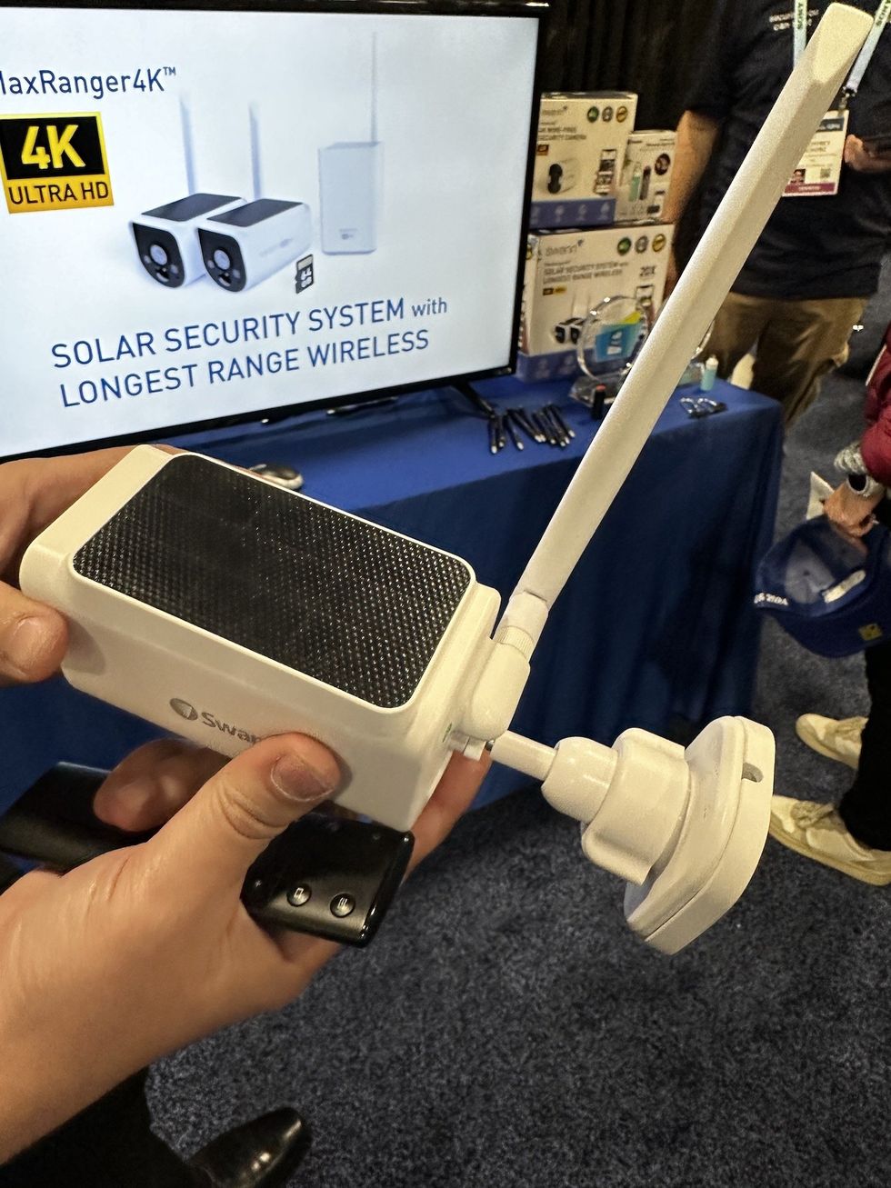 a photo of a person holding Swann MaxRanger 4X Solar Wireless Camera at CES Show 2024