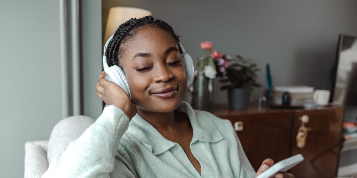young-Black-woman-listening-to-music-peacefully-on-wireless-headphones