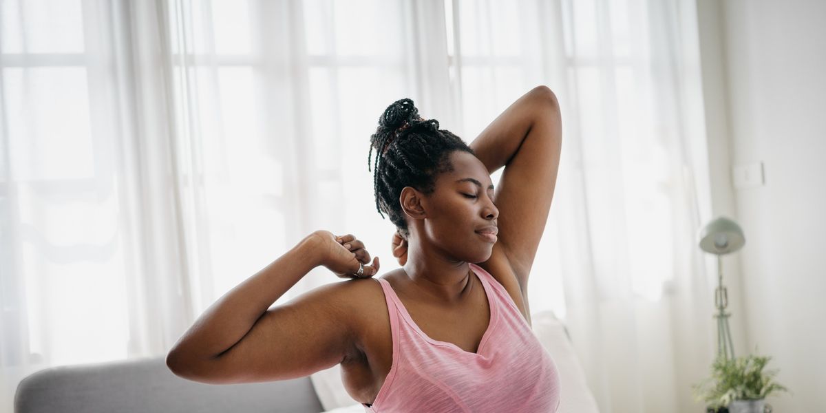 young-Black-woman-stretches-awakens-in-the-morning-light