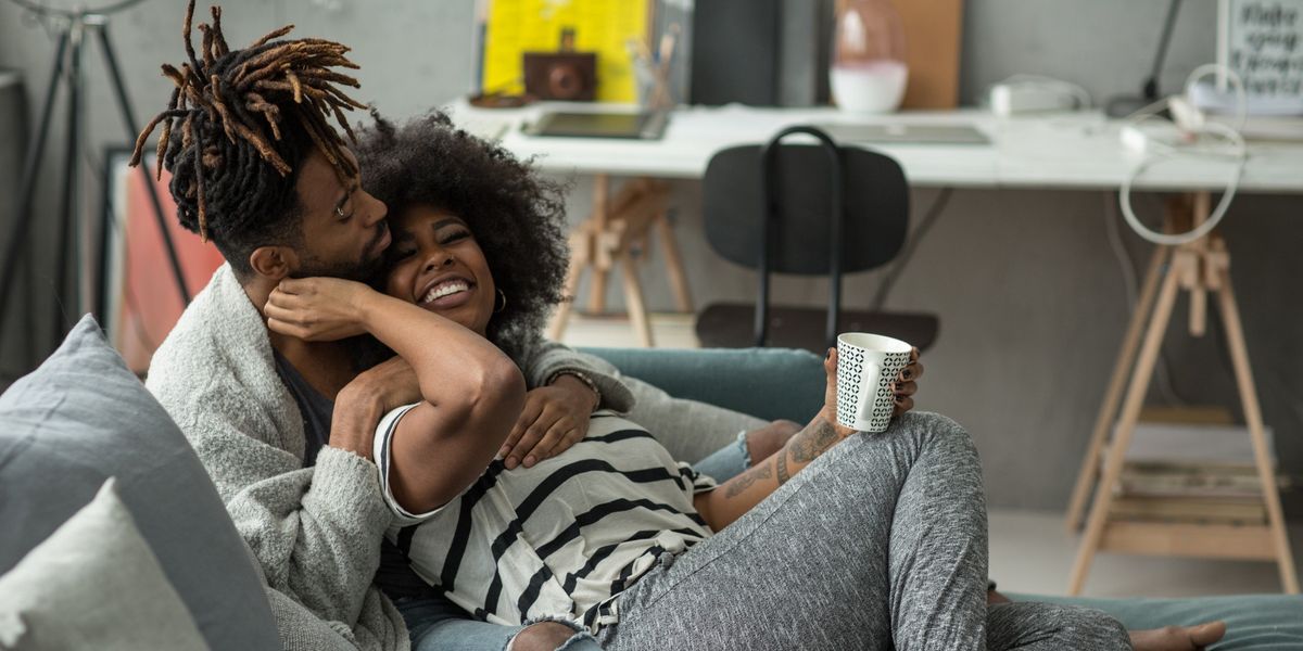 Black-couple-sharing-loving-embrace-on-a-couch