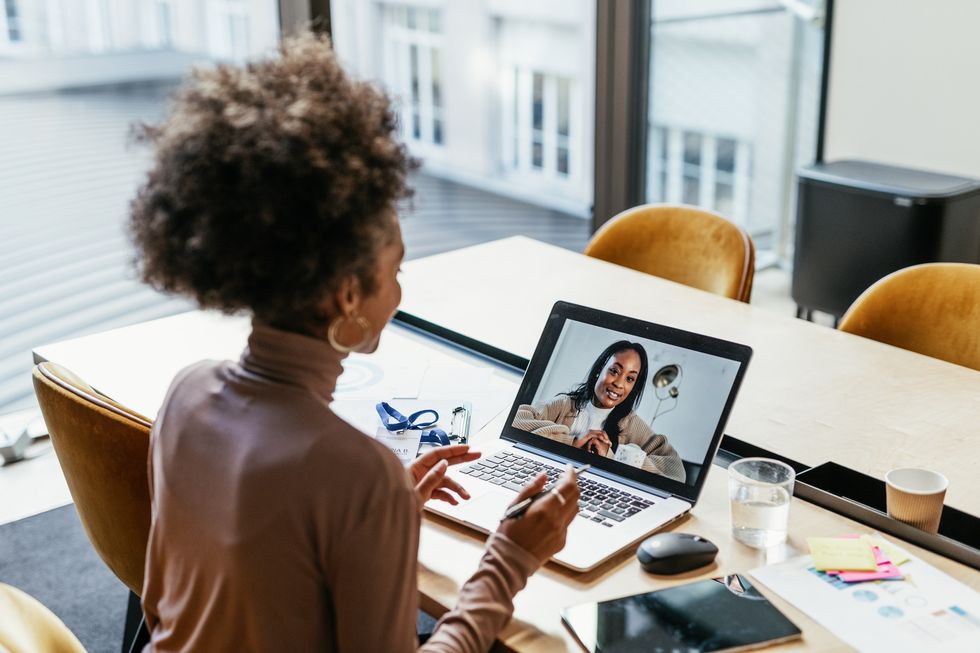 young-woman-on-video-conference-call-in-office-with-a-colleague