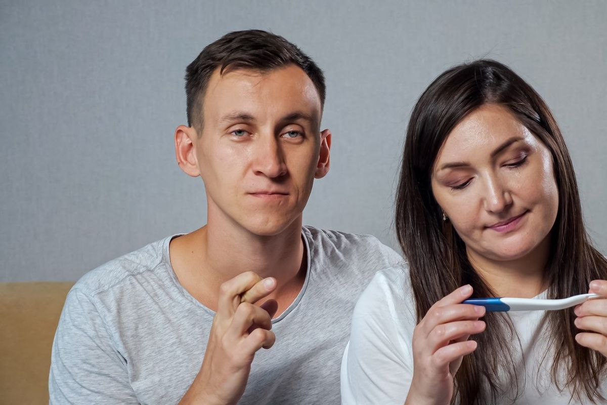 a man and woman waiting to see if the pregnancy test is positive or negative.