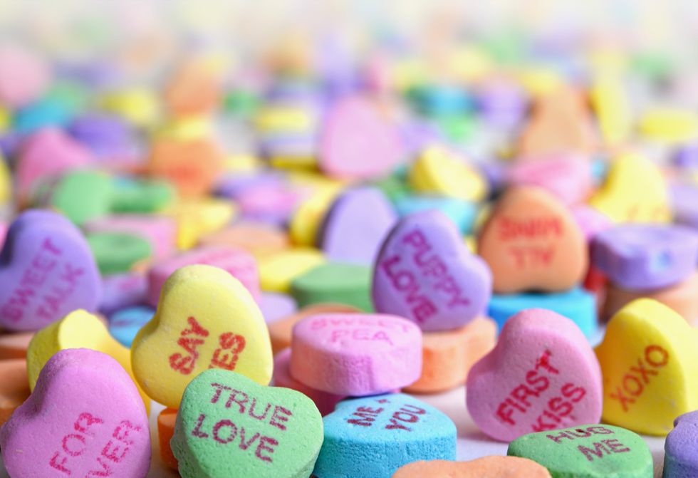 multi-colored candy hearts with words on them