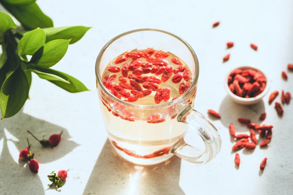 Close-up-goji-berry-tea-in-glass-tea-cup-goji-berries-in-background