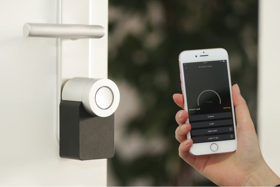 a photo of a Nuki Smart Lock and smartphone using Nuki app to unlock the smart lock.