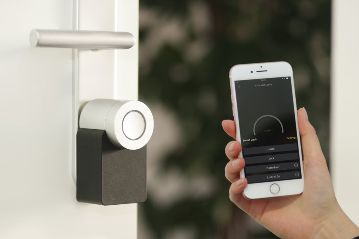 a photo of a Nuki Smart Lock and smartphone using Nuki app to unlock the smart lock.