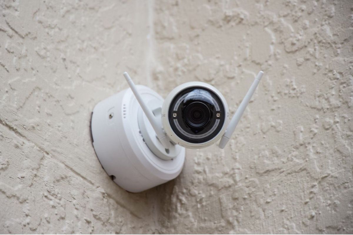 a photo of a smart home security camera installed on the outside of a home.