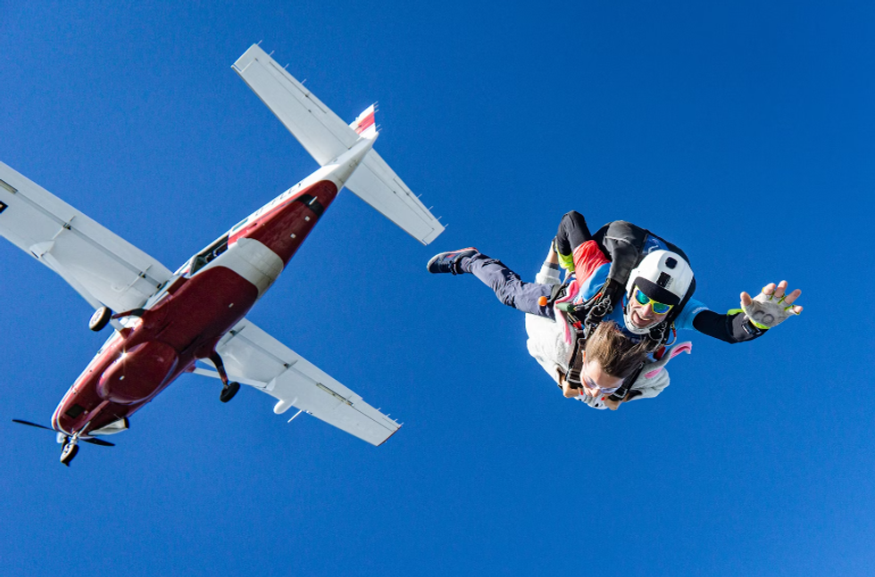 Breathtaking video shows a skydiver bravely flying through a raincloud