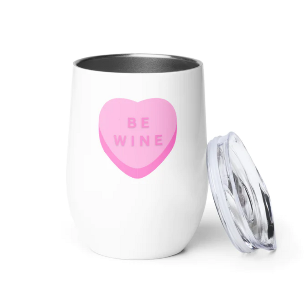 A white wine tumbler with 'Be Mine' written inside a pink heart.
