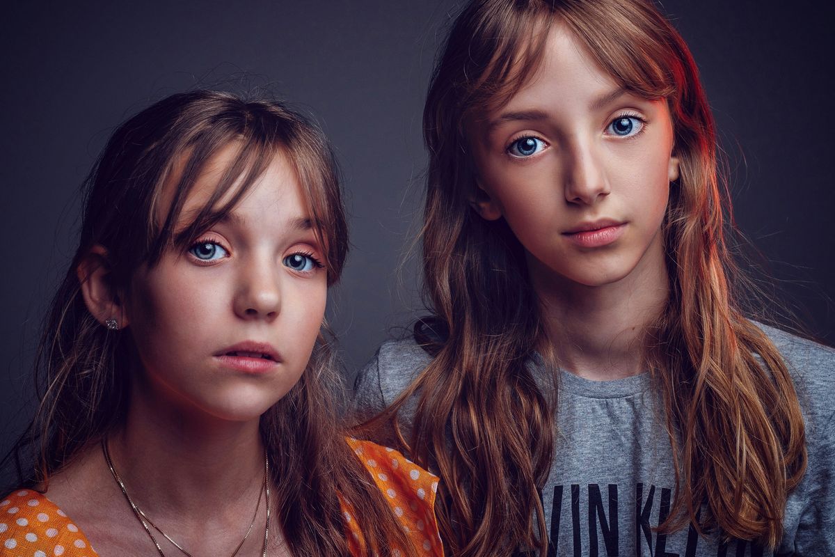 two girls in shirts posing for photo