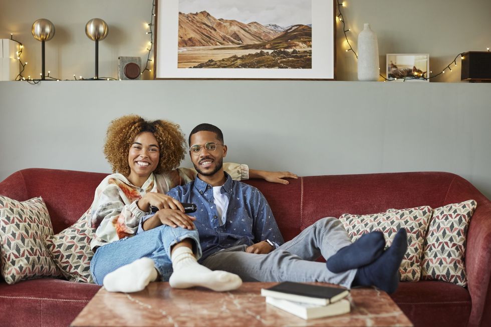 Black couple relaxing on the couch.