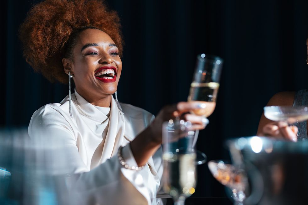 Black woman celebrating with champagne