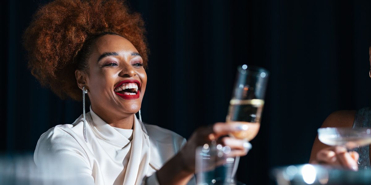 Black woman celebrating with champagne