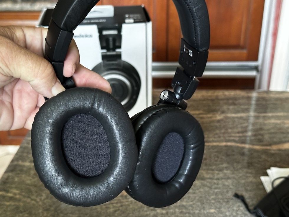 a photo of audio-technica ATH-M50xBT2 Wireless Headphones in a person's hand