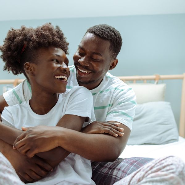 Black-couple-sharing-an-embrace-in-bed