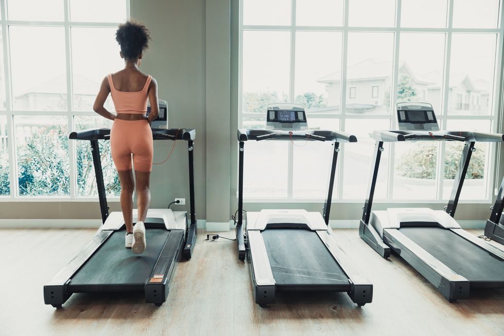 Fit-young-woman-walking-on-treadmill-retro-movement